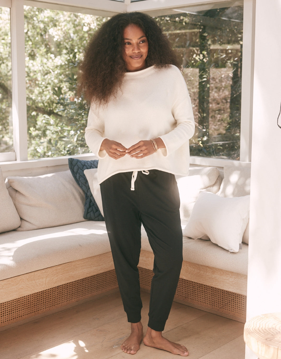 Image of a model wearing Pants. Productname: The Sunday Lounge Pant - in Black colour by brand - White & Co.