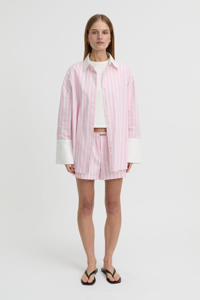 Image of a model wearing Shorts. Product name - Opal Shorts Pink in Pink colour by brand - Blanca Studio