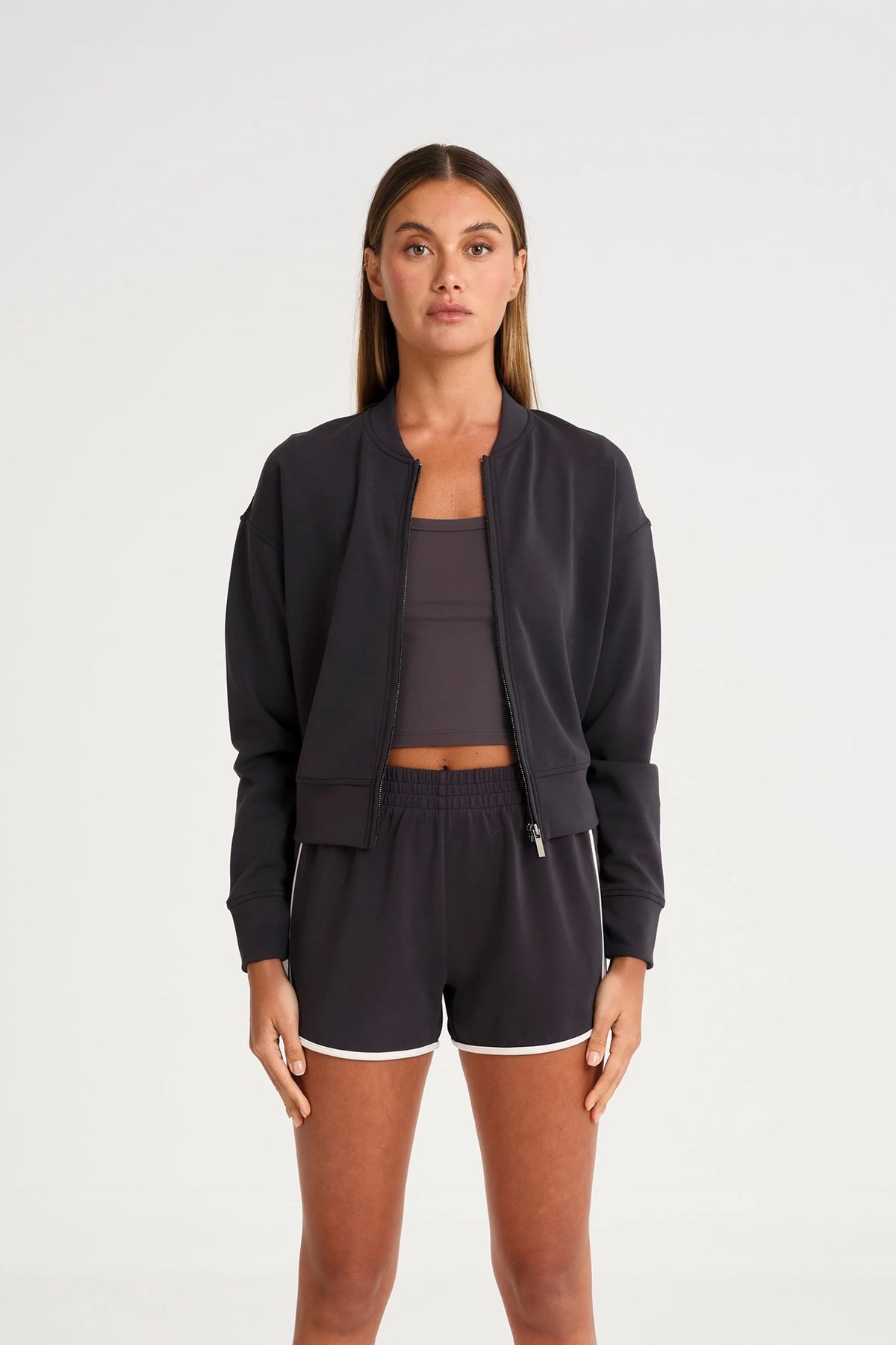 Image of a model wearing Outerwear. Product name - Soft Luxury Full Zip Jumper in Charcoal colour by brand - All Fenix