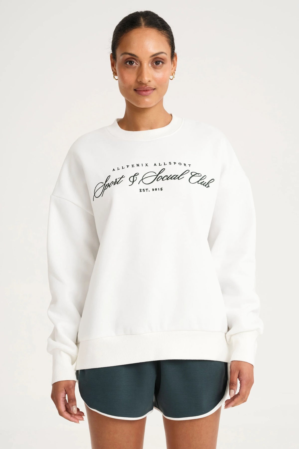 Image of a model wearing Outerwear. Product name - Collegiate Graphic Crew Neck Jumper in White colour by brand - All Fenix