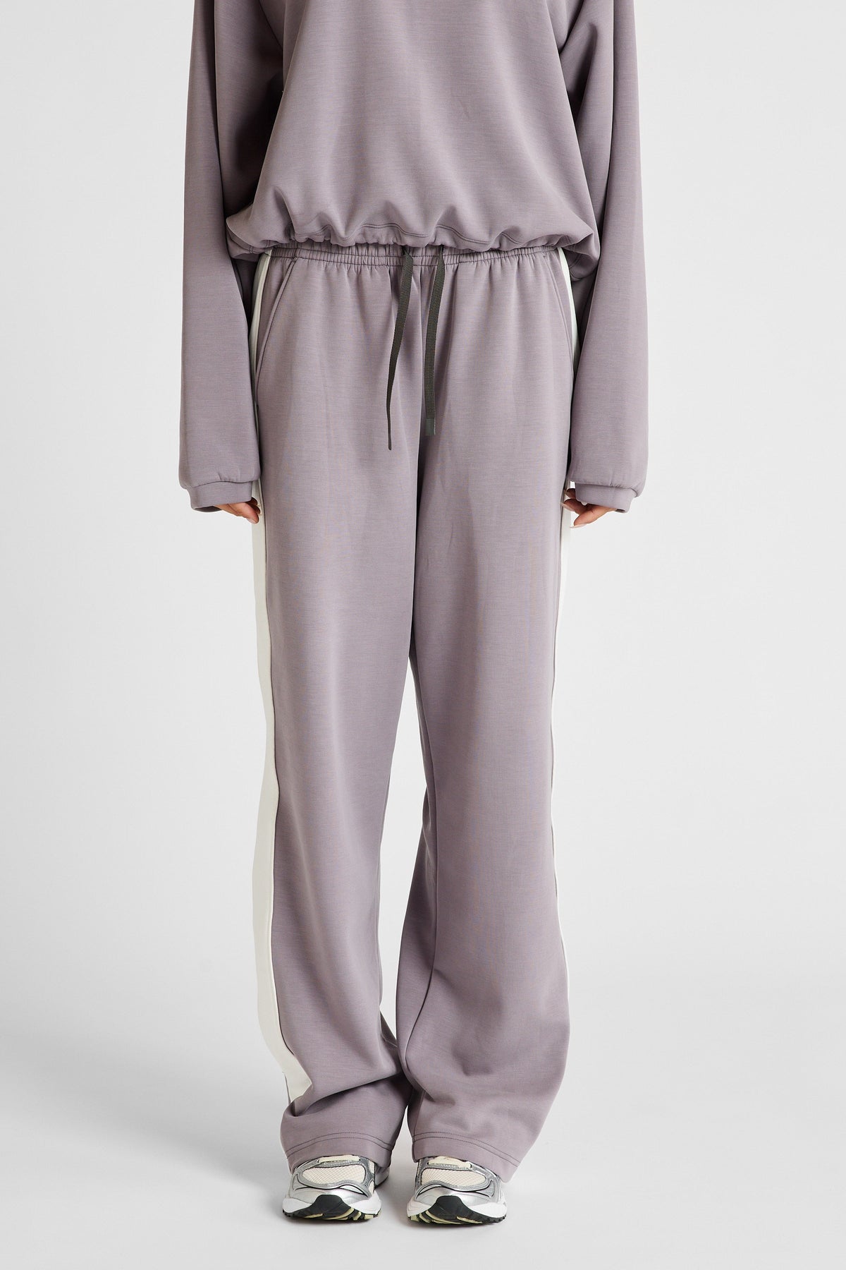 Image of a model wearing Pants. Product name - Soft Essentials Contrast Wide Leg Pant Graphite/Chalk in Chalk colour by brand - All Fenix