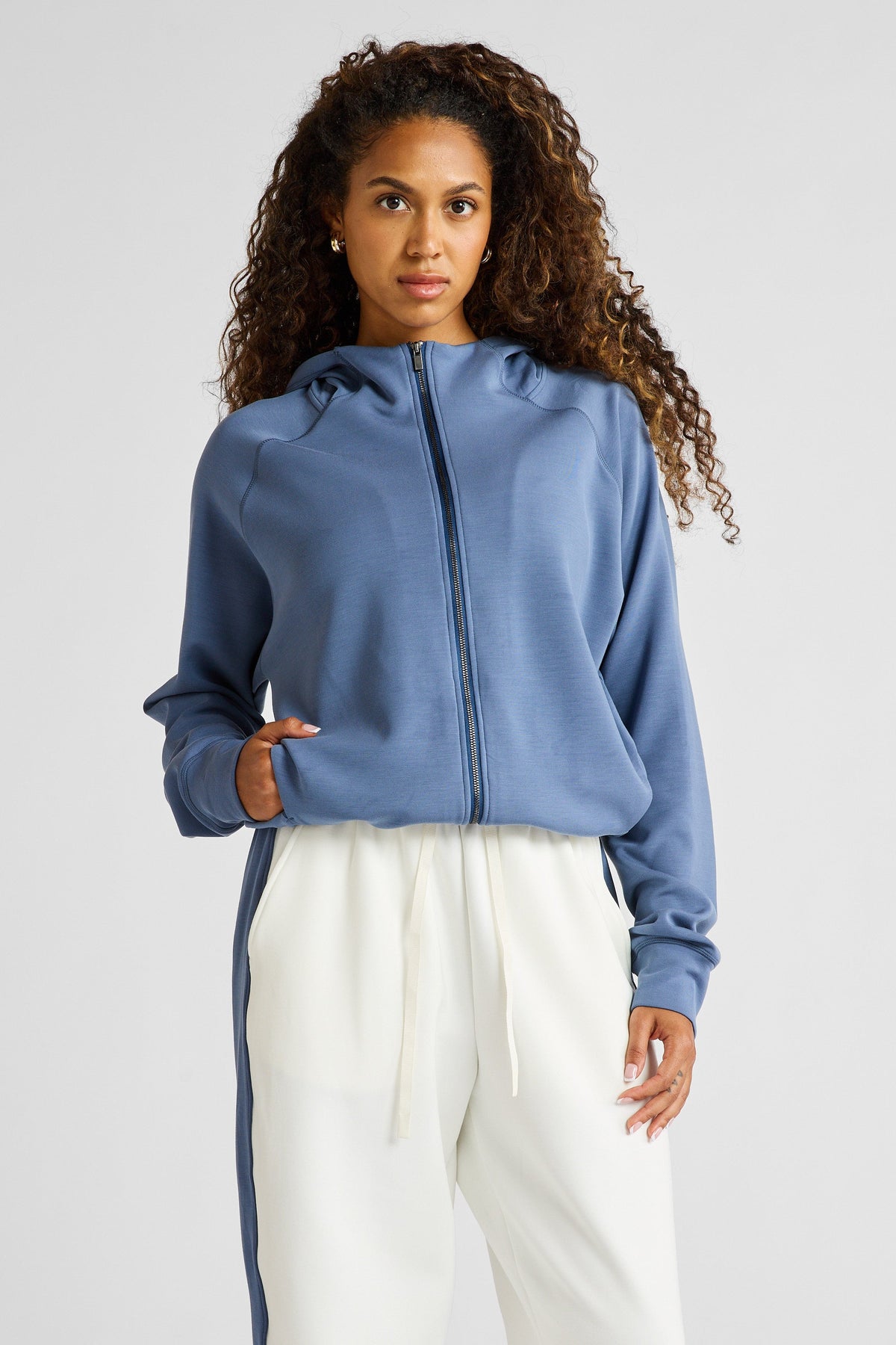 Image of a model wearing Outerwear. Product name - Soft Essentials Cropped Hoodie in Blue colour by brand - All Fenix