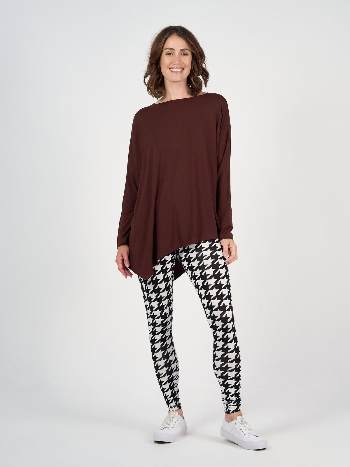 Image of a model wearing Tops. Product name - Susie Oversized Asymmetrical Bamboo Top Burgundy in Burgundy colour by brand - Lou Lou
