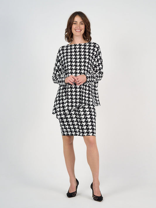 Image of a model wearing Tops. Product name - Susie Oversized Asymmetrical Bamboo Top Houndstooth in Houndstoth colour by brand - Lou Lou
