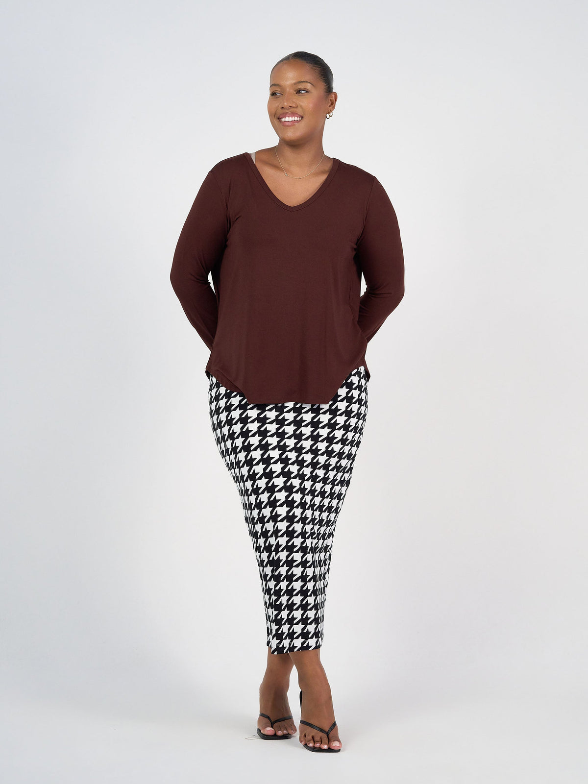 Image of a model wearing Tops. Product name - Sia V Neck Bamboo Longsleeve Top Burgundy in Burgundy colour by brand - Lou Lou