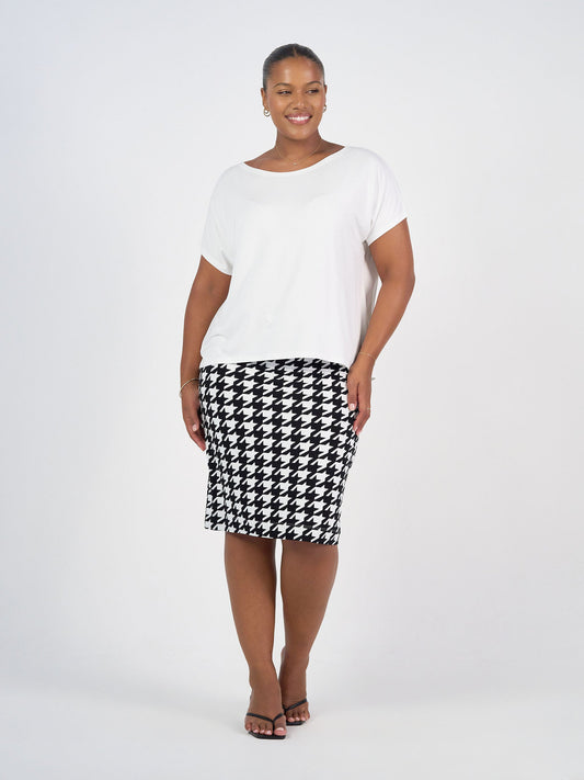 Image of a model wearing Skirts. Product name - Midi Bamboo Whitney Tube Skirt Houndstooth in Houndstoth colour by brand - Lou Lou