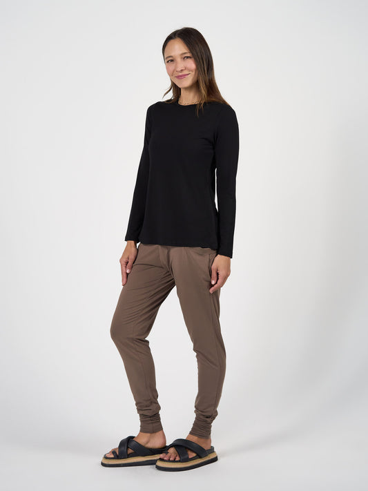 Image of a model wearing Tops. Product name - Jones Long Sleeve Fitted Bamboo Top in Black colour by brand - Lou Lou