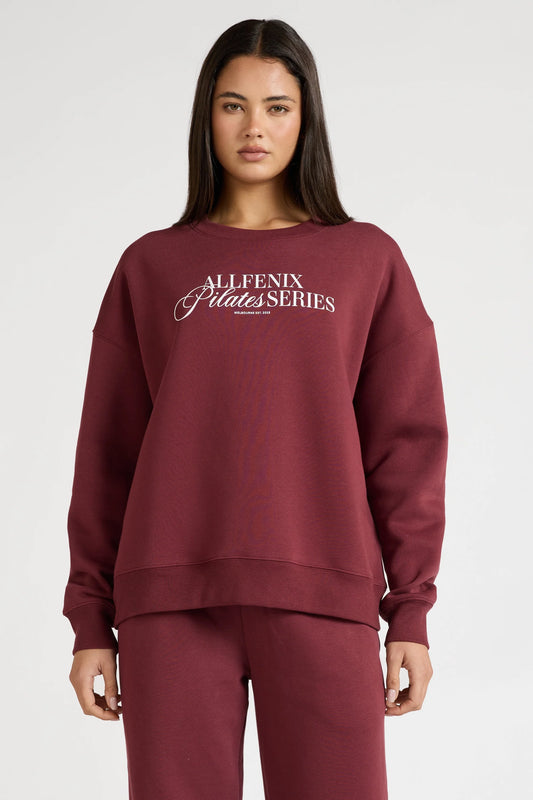 Image of a model wearing Outerwear. Product name - Pilates Series Crew Jumper in Burgundy colour by brand - All Fenix