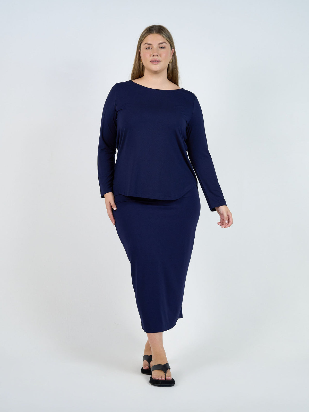 Image of a model wearing Tops. Product name - Adele Long Sleeve Bamboo Top Navy in Navy colour by brand - Lou Lou