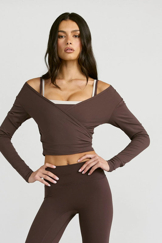 Image of a model wearing Tops. Product name - ALLFENIX CloudCore Lite Long Sleeve Wrap Top in Espresso colour by brand - All Fenix
