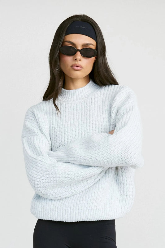 Image of a model wearing Outerwear. Product name - Funnel Neck Knit in Grey colour by brand - All Fenix