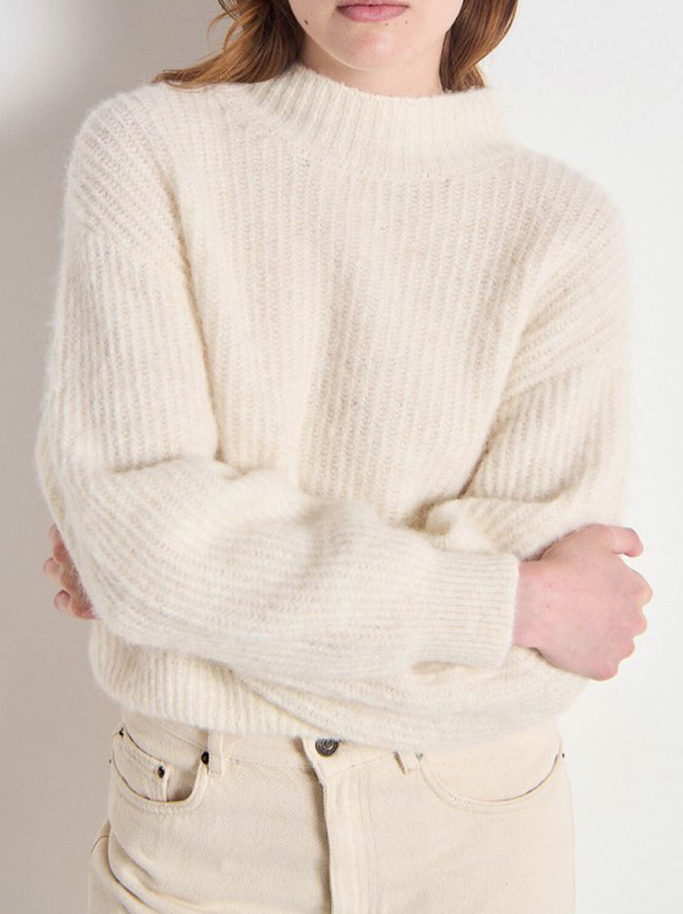 Image of a model wearing Outerwear. Product name - AMERICAN VINTAGE EAST MOCK NECK KNIT in Mother Of Pearl colour by brand - American Vintage