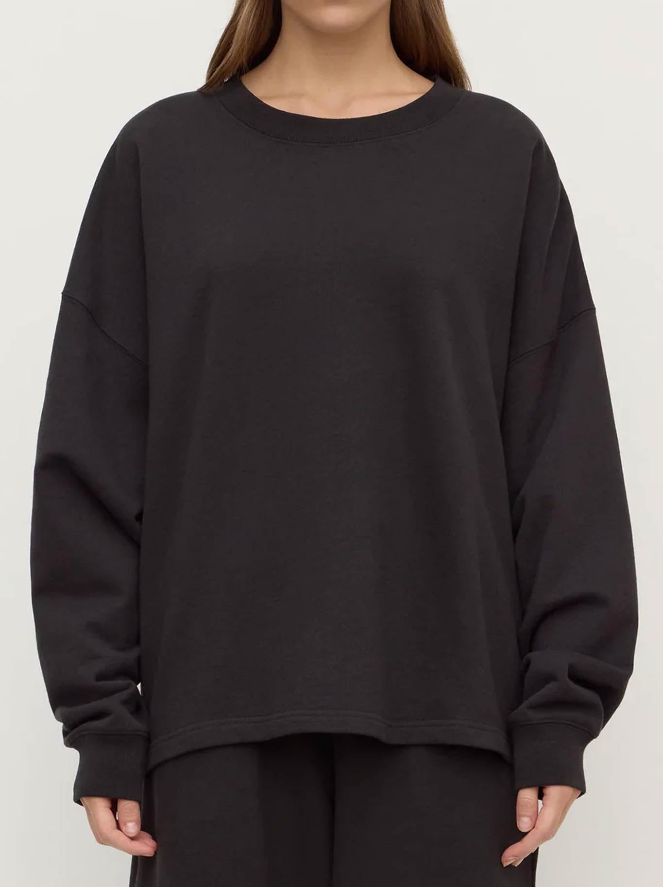 Image of a model wearing Tops. Product name - ASSEMBLY LABEL BRUSHED COTTON LOUNGE SWEATER in Black colour by brand - Assembly Label