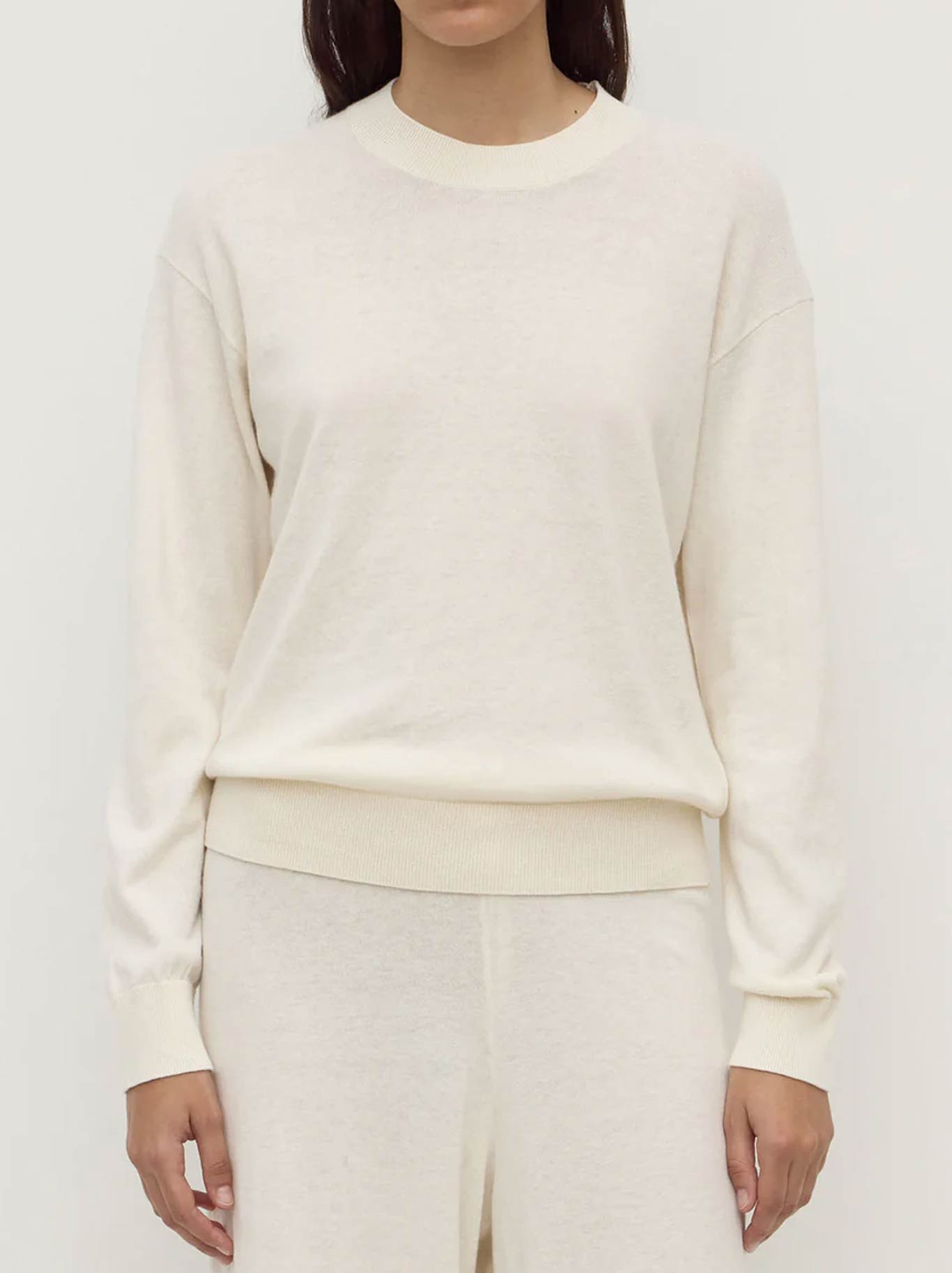 Image of a model wearing Outerwear. Productname: ASSEMBLY LABEL COTTON CASHEMRE SWEATER in Cream colour by brand - Assembly Label