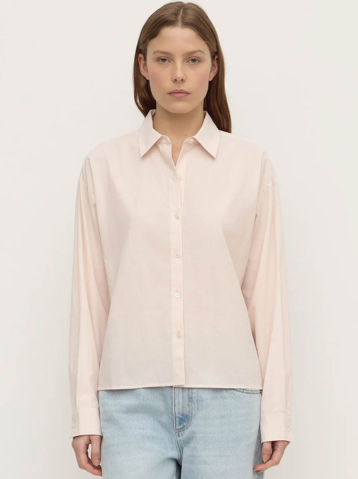 Image of a model wearing Tops. Product name - ASSEMBLY LABEL FRANKIE COTTON LONG SLEEVE SHIRT in Soft Rose colour by brand - Assembly Label
