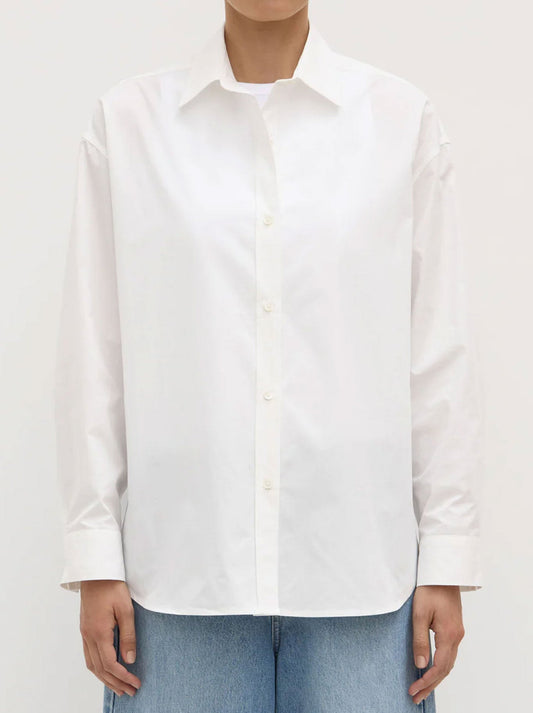 Image of a model wearing Tops. Product name - ASSEMBLY LABEL MARIGOLD POPLIN SHIRT in White colour by brand - Assembly Label