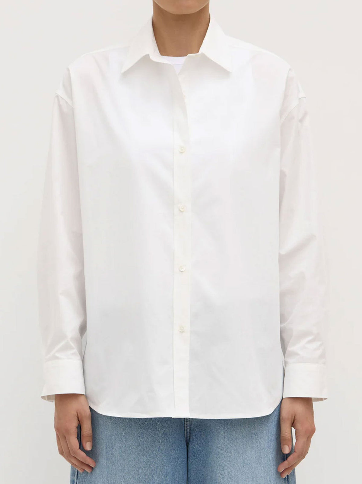 Image of a model wearing Tops. Product name - ASSEMBLY LABEL MARIGOLD POPLIN SHIRT in White colour by brand - Assembly Label