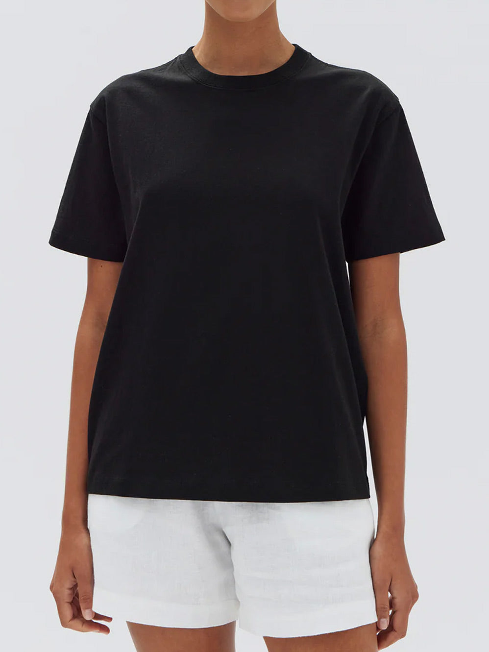 Image of a model wearing Tops. Productname: ASSEMBLY LABEL ORGANIC BASE TEE in Black colour by brand - Assembly Label