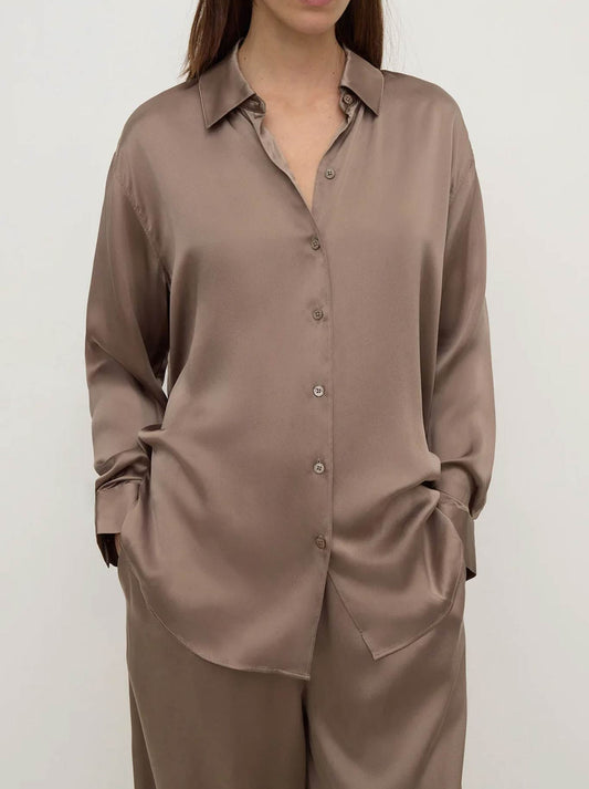 Image of a model wearing Tops. Product name - ASSEMBLY LABEL PIPPA SILK LONG SLEEVE SHIRT in Dark/Sand colour by brand - Assembly Label