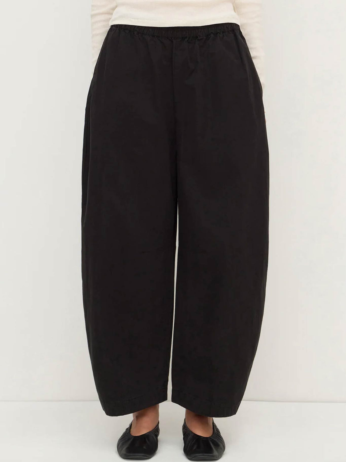 Image of a model wearing Pants. Product name - ASSEMBLY LABEL LOLA BARREL PANT in Black colour by brand - Assembly Label