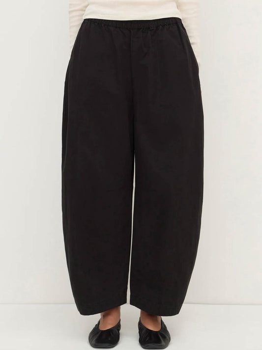 Image of a model wearing Pants. Product name - ASSEMBLY LABEL LOLA BARREL PANT in Black colour by brand - Assembly Label