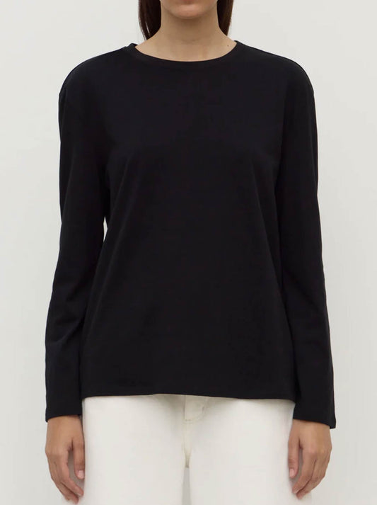 Image of a model wearing Tops. Product name - ASSEMBLY LABEL THEA LONG SLEEVE TEE WHITE in Black colour by brand - Assembly Label
