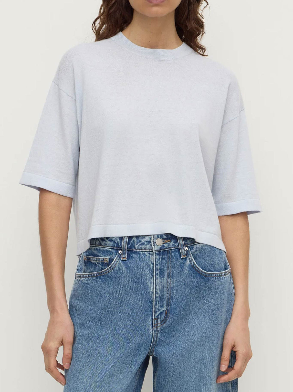 Image of a model wearing Tops. Product name - ASSEMBLY LABEL KENSY COTTON CASHMERE TEE in Black colour by brand - Assembly Label