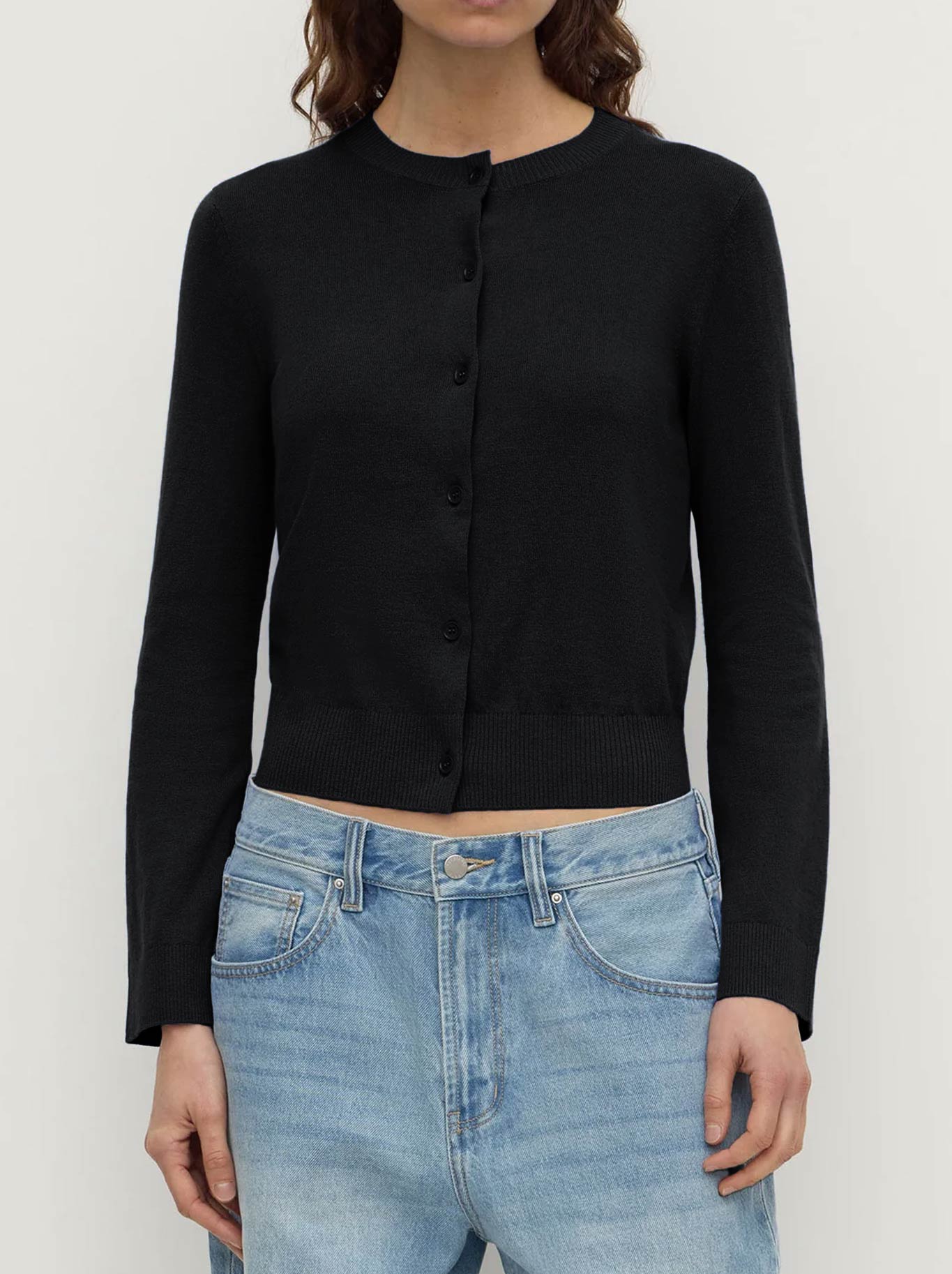 Image of a model wearing Tops. Product name - ASSEMBLY LABEL ORINA COTTON CASHMERE CARDI in Black colour by brand - Assembly Label