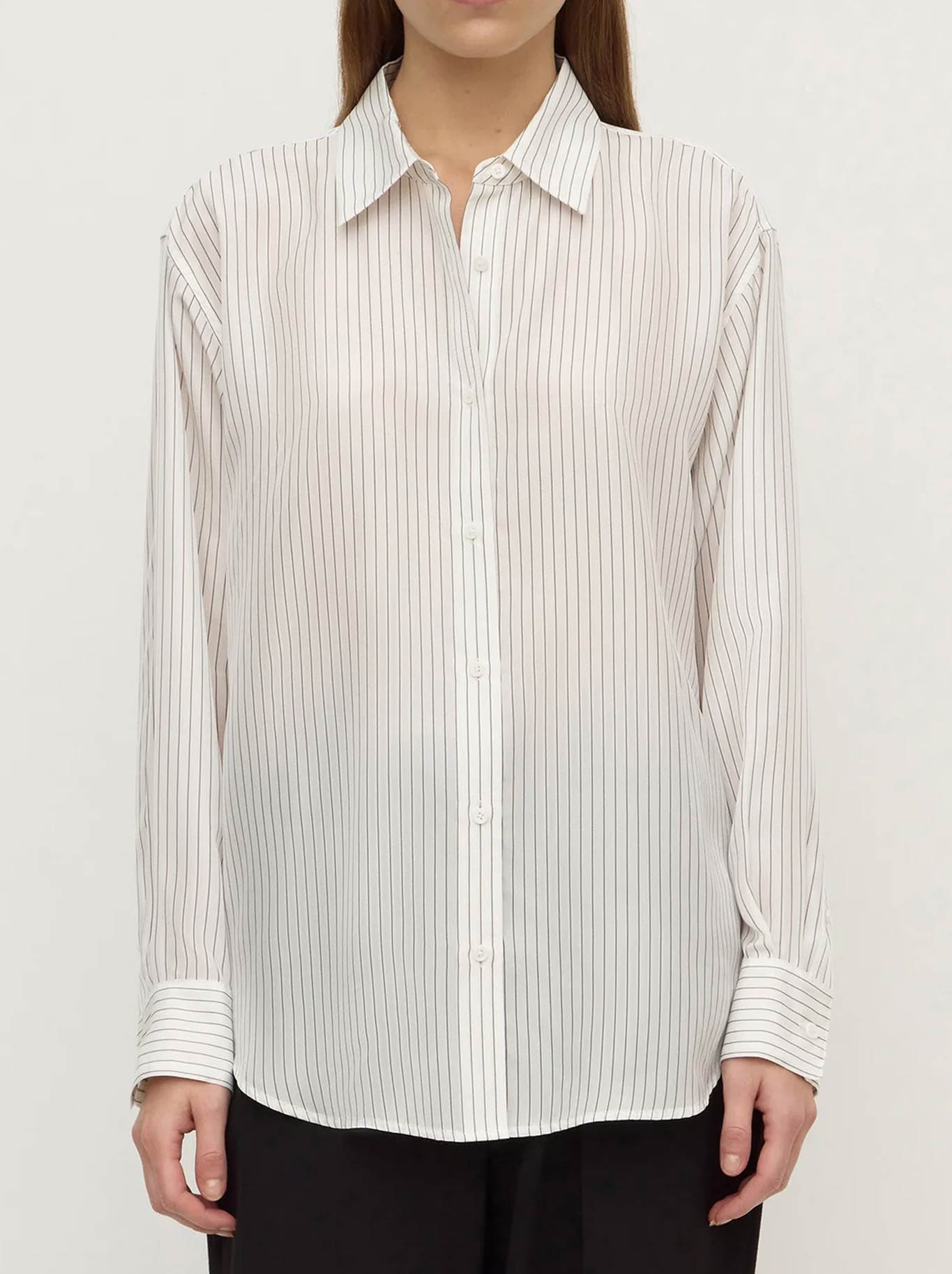 Image of a model wearing Tops. Product name - ASSEMBLY LABEL SASKIA SILK SHIRT in Cream colour by brand - Assembly Label