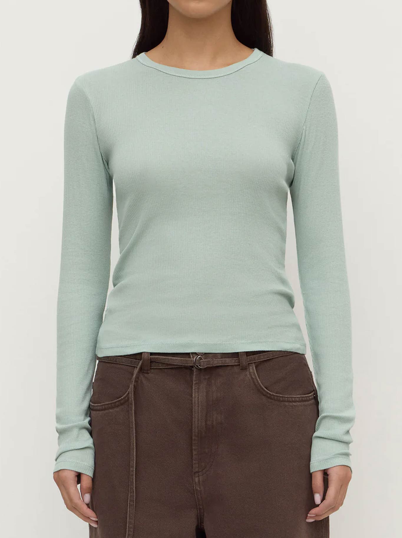 Image of a model wearing Tops. Product name - ASSEMBLY LABEL ZALI LONG SLEEVE TEE in Mint colour by brand - Assembly Label