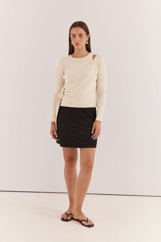 Image of a model wearing Outerwear. Product name - Azalea Wrap Sweater Cream in Cream colour by brand - Sass Clothing