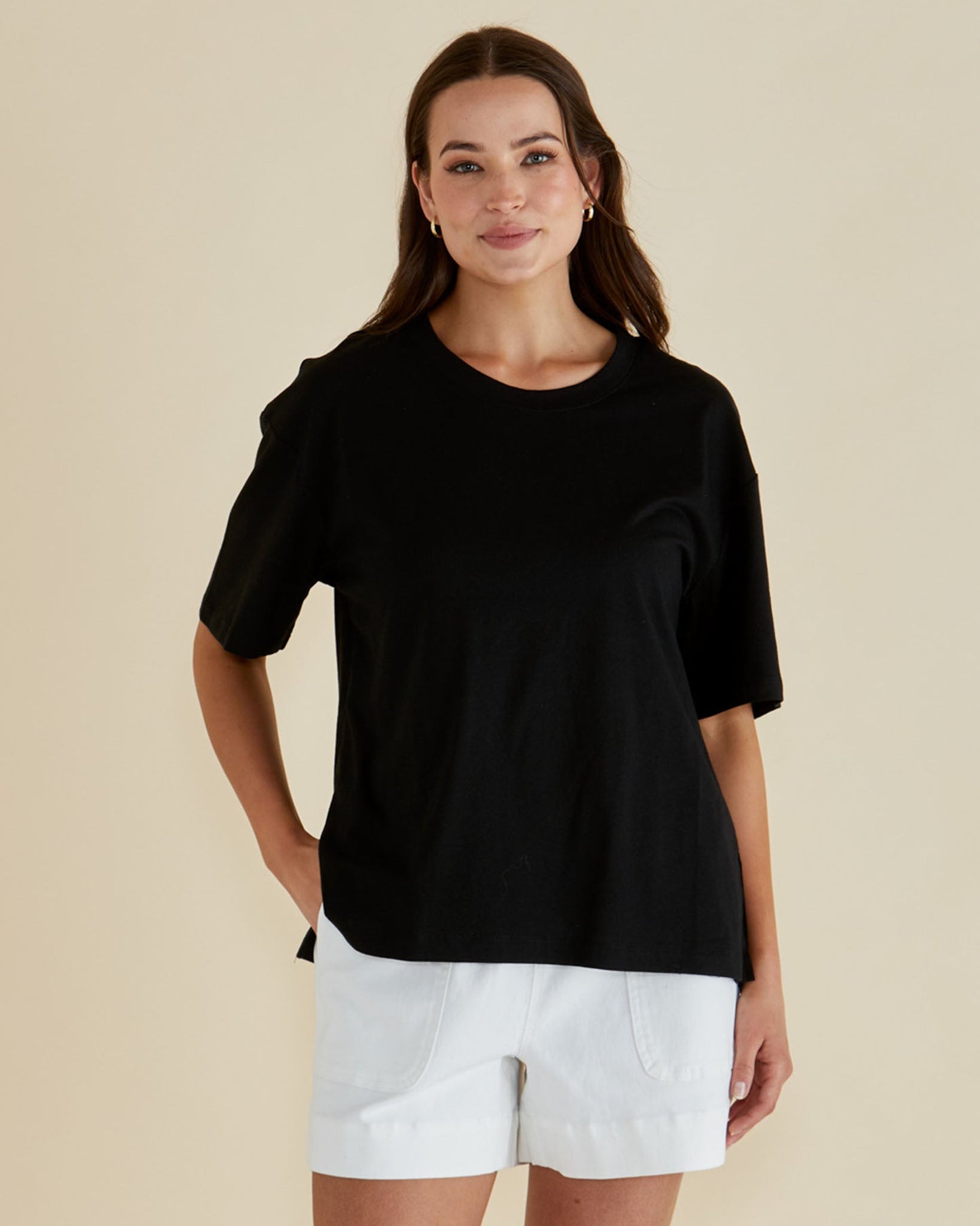 Image of a model wearing Tops. Productname: Betty Basics Relax Boxy Tee Black in Black colour by brand - Betty Basics