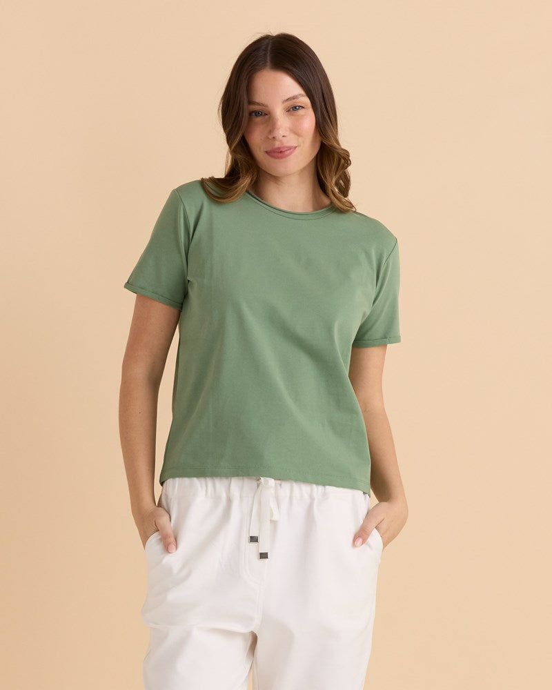 Image of a model wearing Tops. Productname: Betty Basics Cotton Slim Fit Tee Green in Green colour by brand - Betty Basics