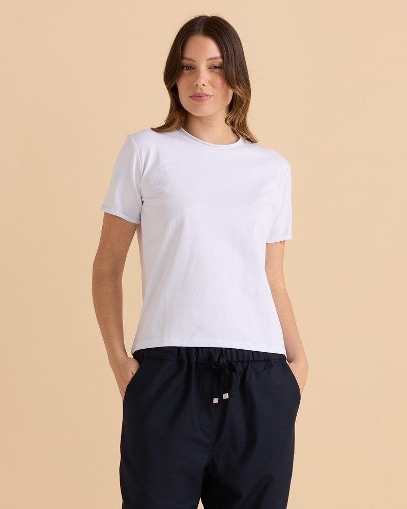 Image of a model wearing Tops. Productname: Betty Basics Cotton Slim Fit Tee White in White colour by brand - Betty Basics