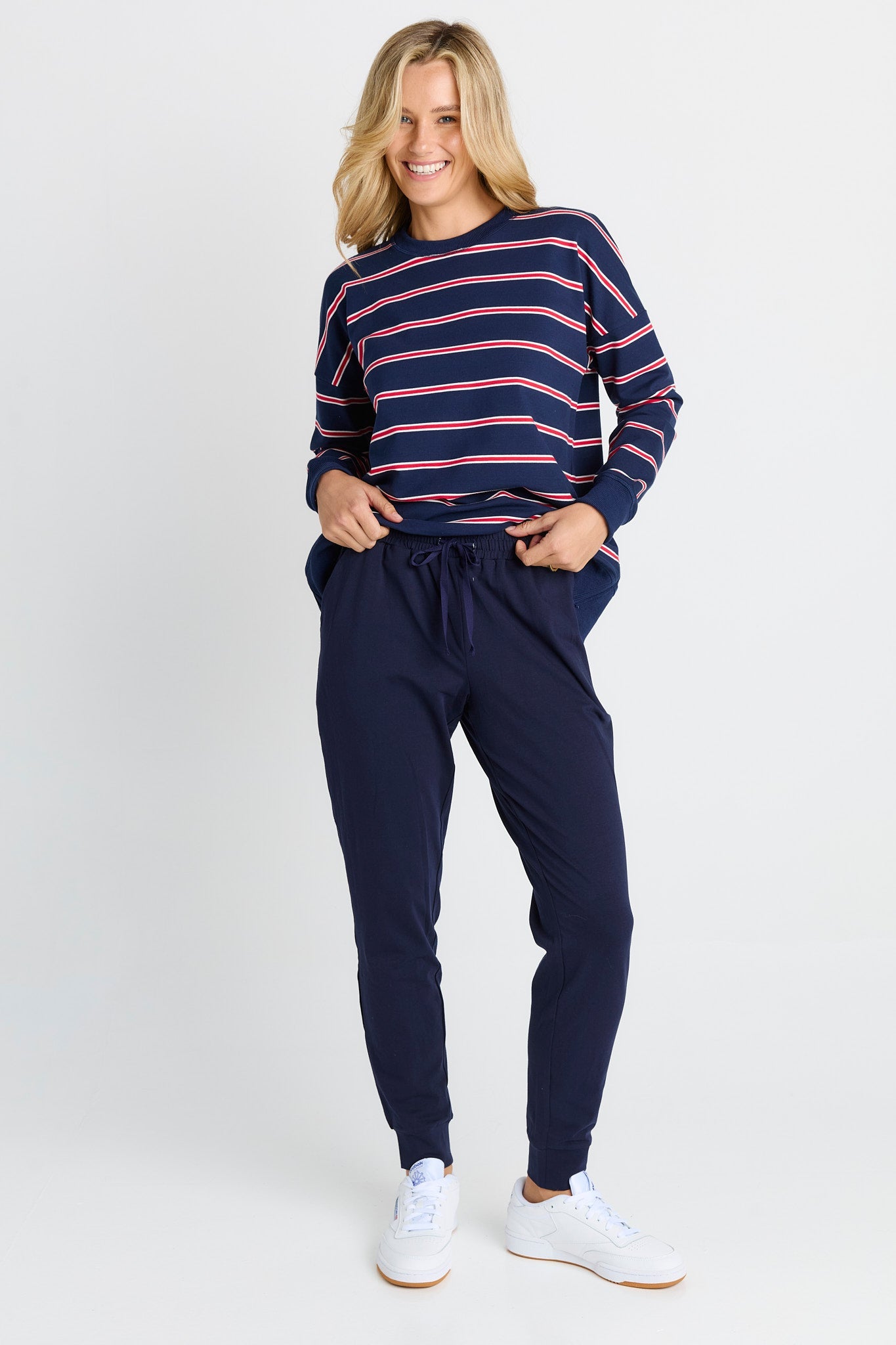 Image of a model wearing Pants. Product name - Heidi Pant Navy in Navy colour by brand - Betty Basics