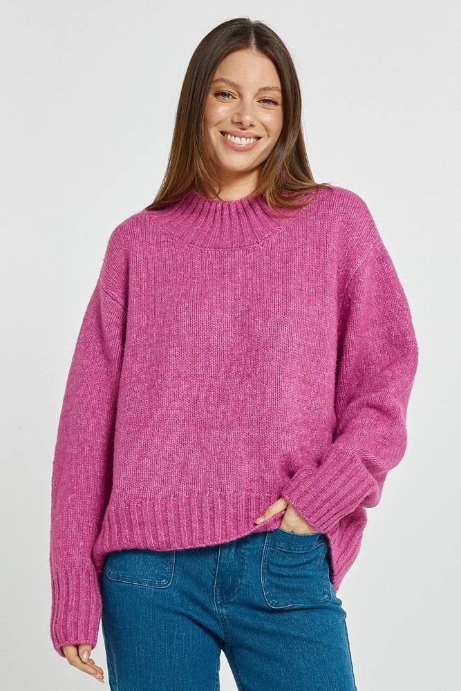 Image of a model wearing Outerwear. Product name - Lola Jumper Mulberry in Mulberry colour by brand - Betty Basics