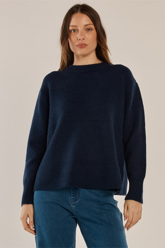 Image of a model wearing Outerwear. Product name - Camryn Knit Sweater Navy in Navy colour by brand - Betty Basics