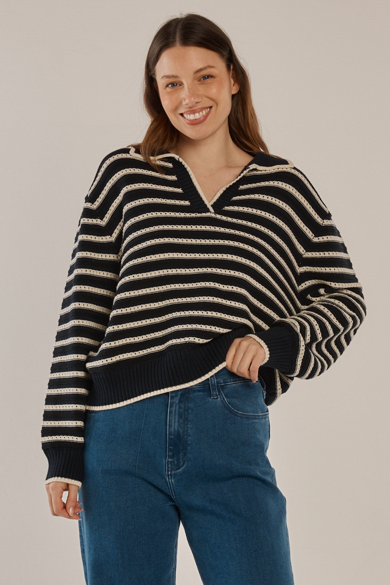 Image of a model wearing Outerwear. Productname: Aberdeen Polo Knit Sweater Navy Stripe in Navy Stripe colour by brand - Betty Basics