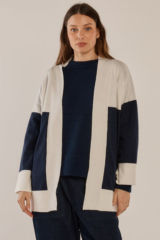 Image of a model wearing Outerwear. Product name - Chase Cardigan Navy/Cream in Navy/Cream colour by brand - Betty Basics