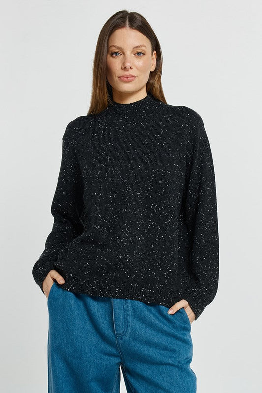Image of a model wearing Outerwear. Product name - Carlin Knit Sweater Black in Black colour by brand - Betty Basics