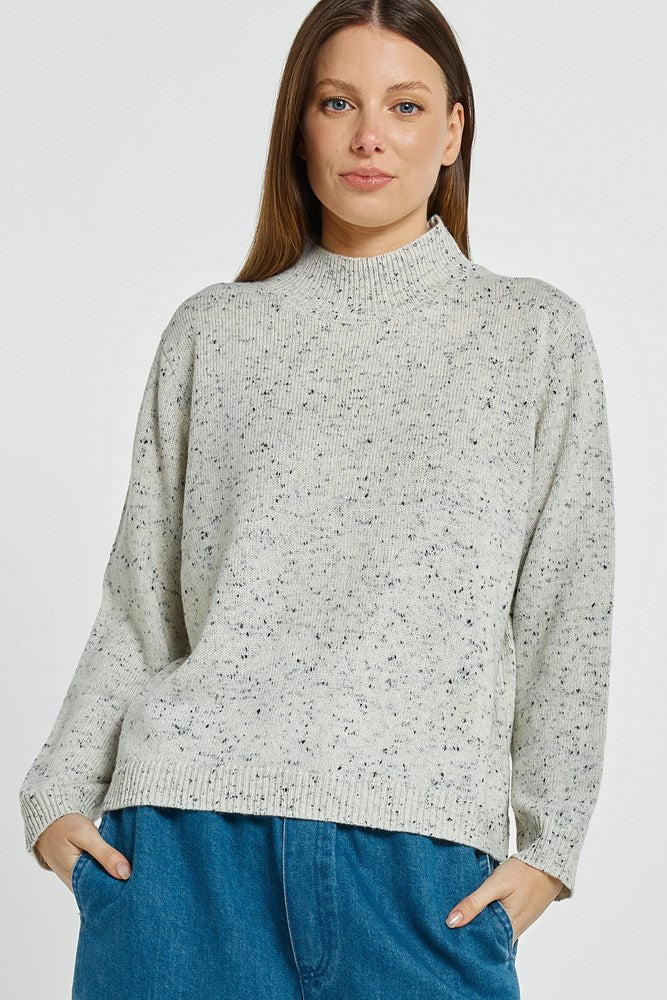 Image of a model wearing Outerwear. Product name - Carlin Knit Sweater Cream in Cream colour by brand - Betty Basics