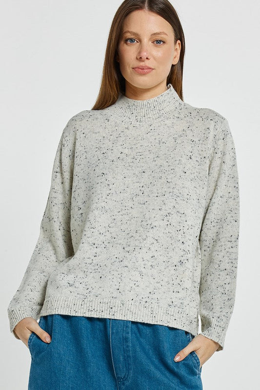 Image of a model wearing Outerwear. Product name - Carlin Knit Sweater Cream in Cream colour by brand - Betty Basics