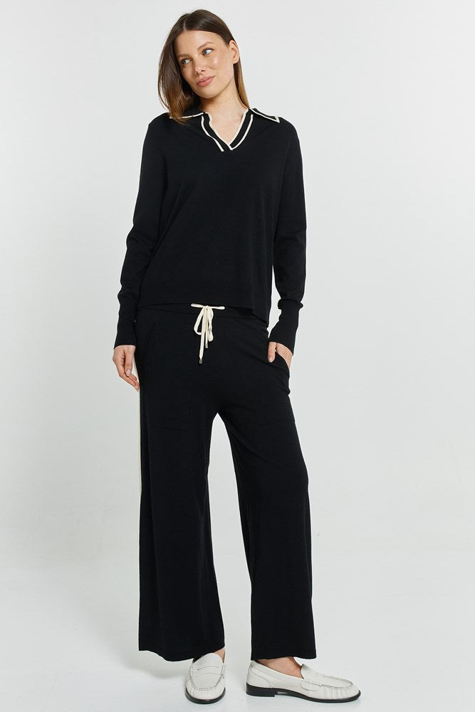 Image of a model wearing Pants. Product name - Makenna Knit Pant Black in Black colour by brand - Betty Basics