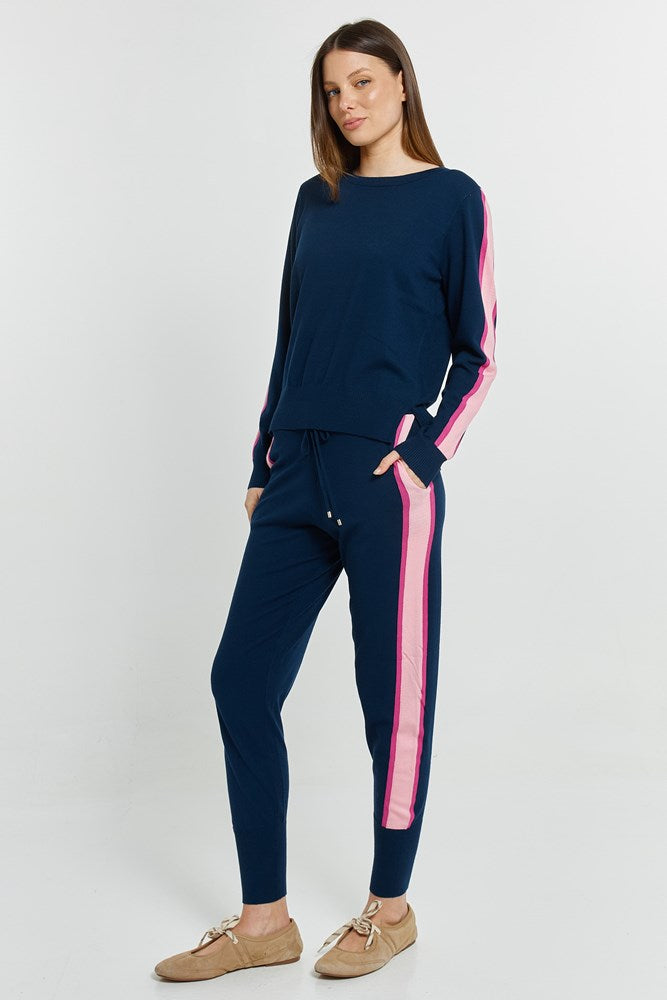 Image of a model wearing Pants. Product name - Lenore Jogger Navy in Navy colour by brand - Betty Basics