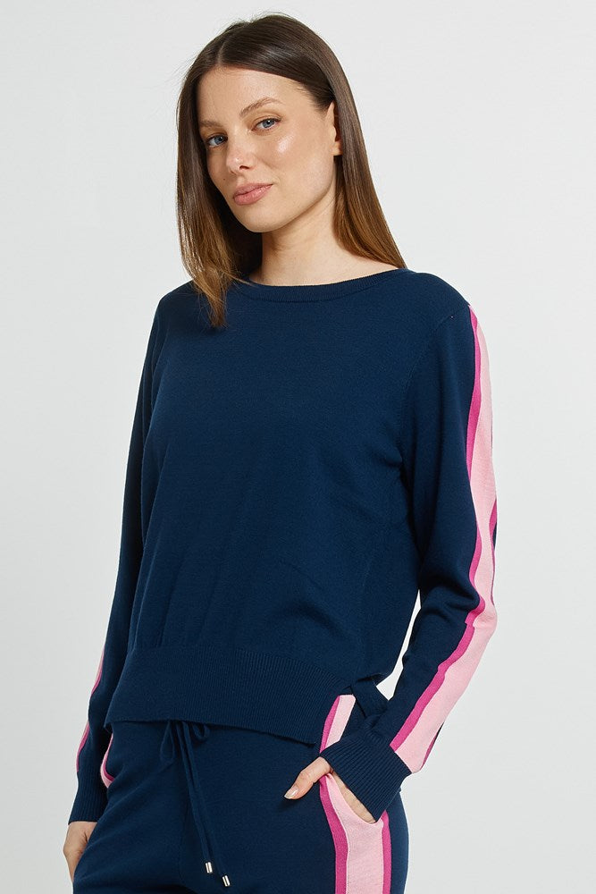Image of a model wearing Outerwear. Product name - Lenore Sweater Navy in Navy colour by brand - Betty Basics