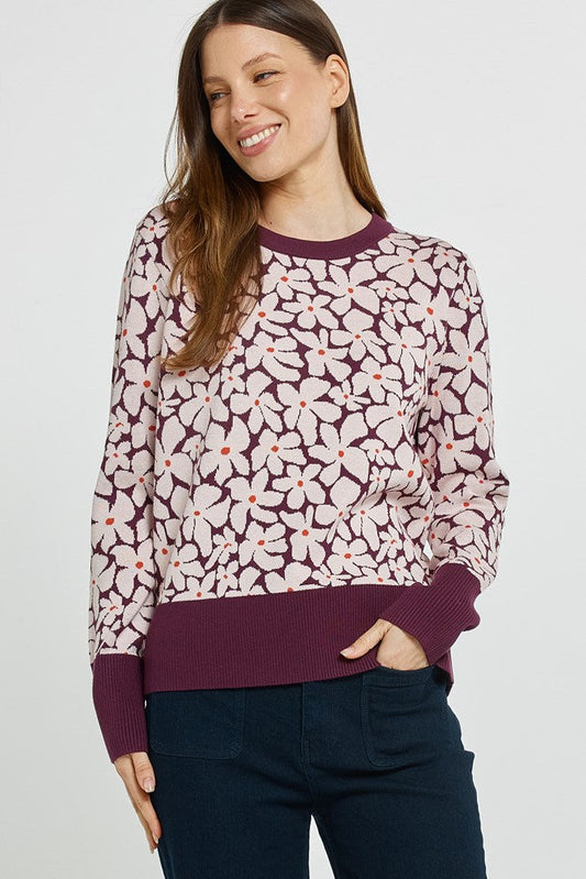 Image of a model wearing Outerwear. Product name - Maisie Sweater Wine Petal Jacquard in Wine Petal Jacquard colour by brand - Betty Basics