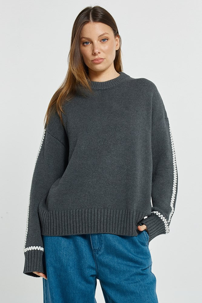 Image of a model wearing Outerwear. Product name - Contrast Stitch Sweater Charcoal in Charcoal colour by brand - Betty Basics