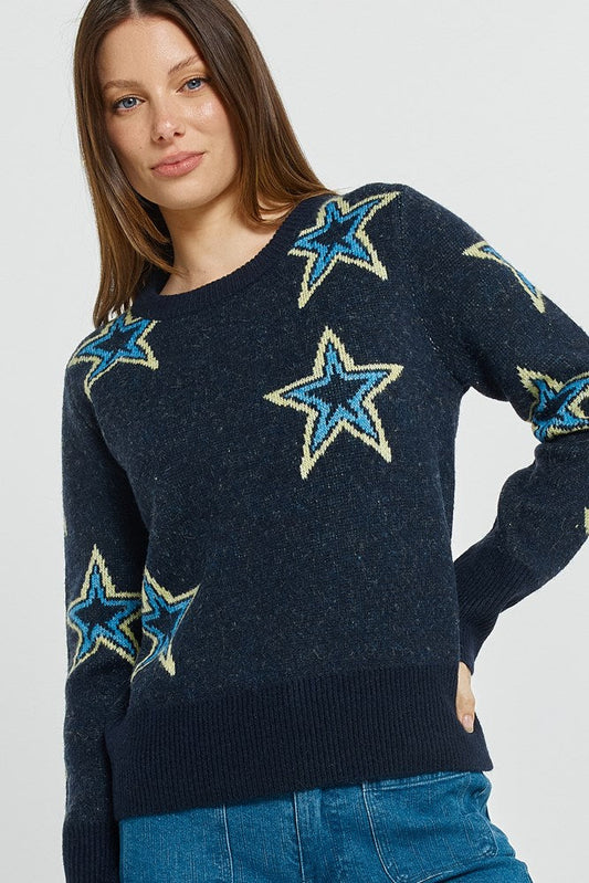 Image of a model wearing Outerwear. Product name - Serena Sweater Star Jacquard in Star Jacquard colour by brand - Betty Basics