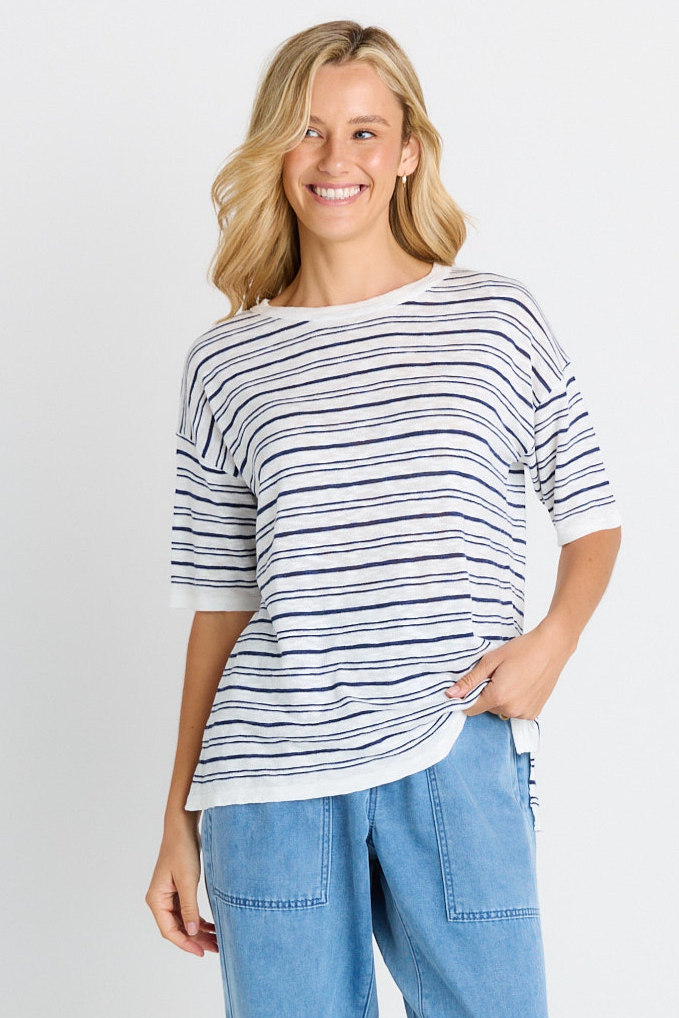 Image of a model wearing Tops. Product name - Eleni Knit Tee in Navy/White Stripe colour by brand - Betty Basics