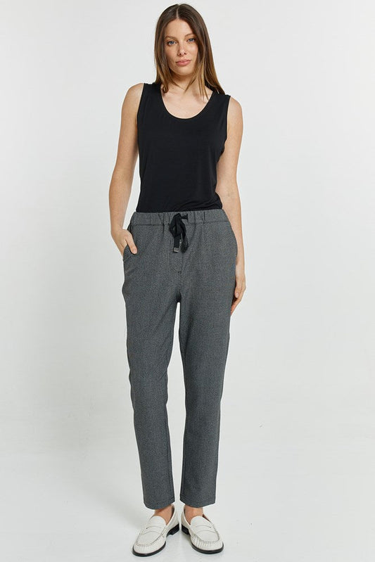 Image of a model wearing Pants. Product name - Kenzie Jogger Grey Check in Grey Check colour by brand - Betty Basics